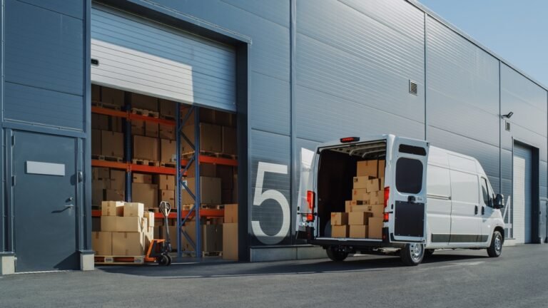 Outside,Of,Logistics,Warehouse,With,Open,Door,,Delivery,Van,Loaded